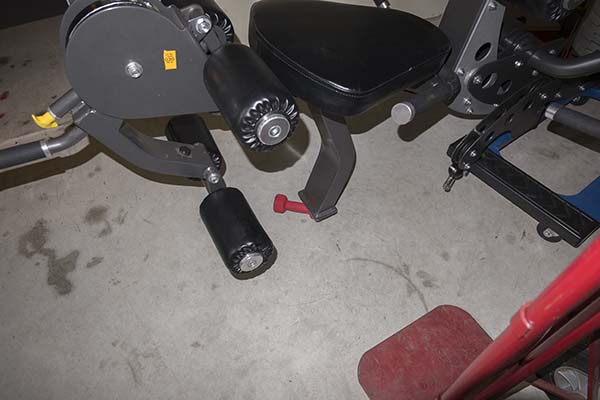 Photograph of Hoist V5 home gym, showing small dumbbell raising the frame so that furniture dolly could be removed.